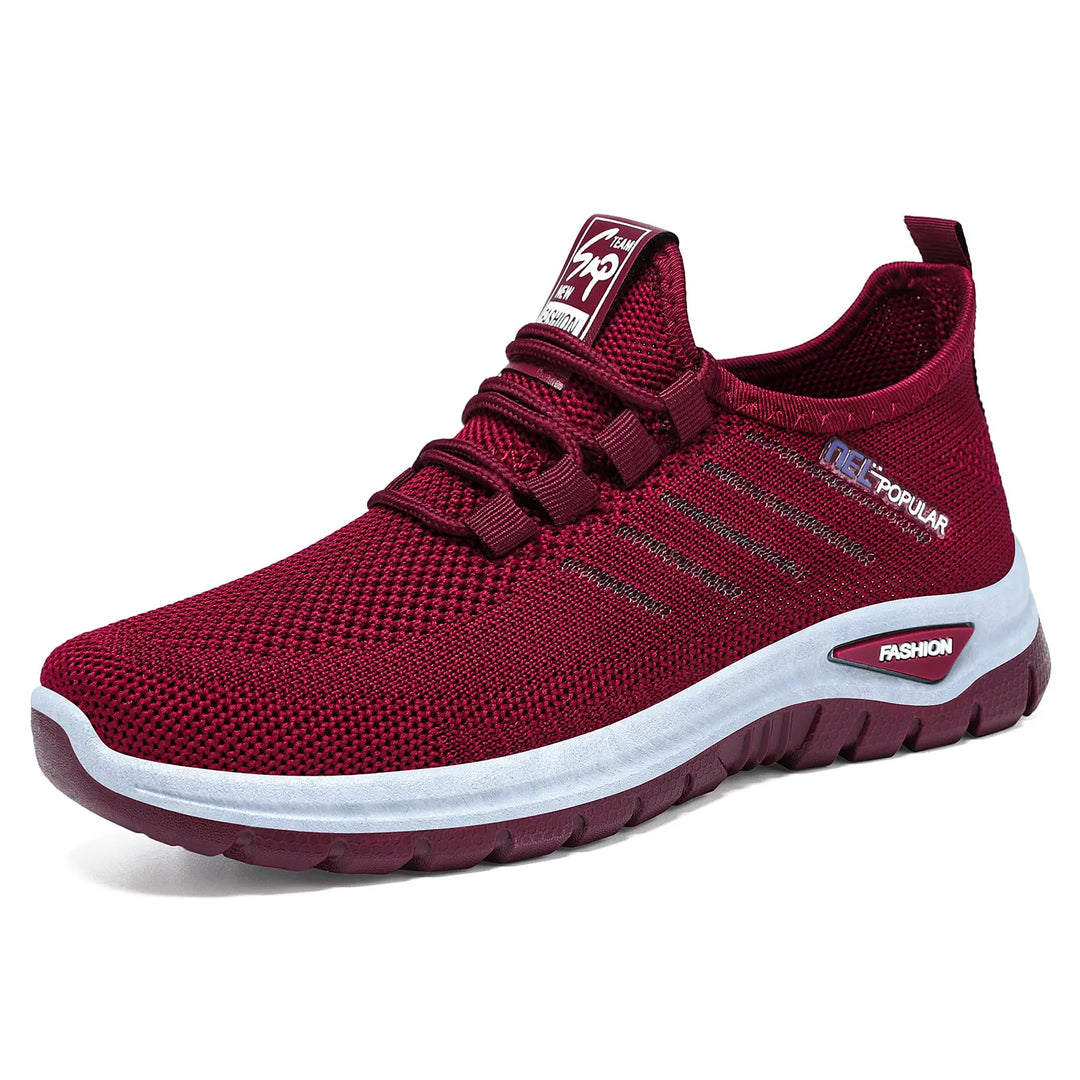 Lightweight red knit slip-on sneakers with a white midsole stripe featuring &