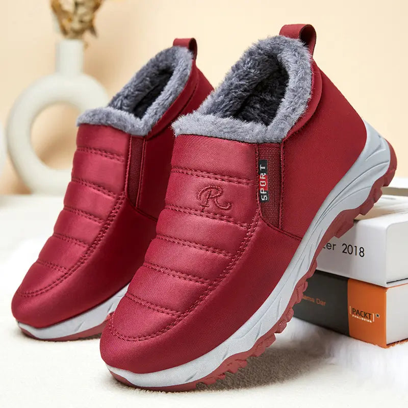 Pair of red quilted Zylpha winter boots with plush faux-fur lining, slip-on design, and visible 'SPORT' label.