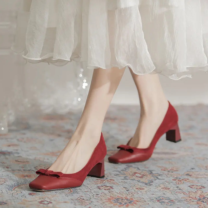A pair of red microsuede women&