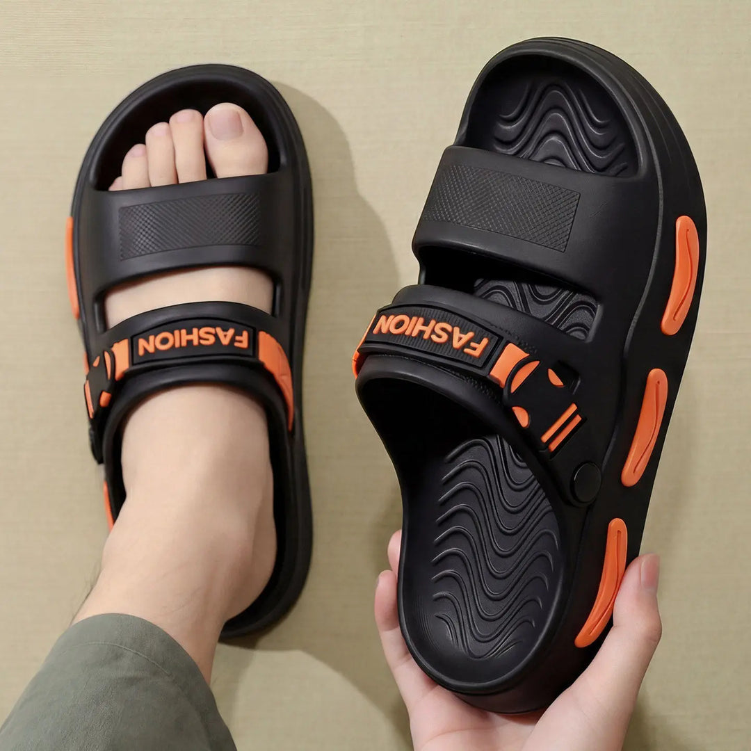 Black Rhyza chunky platform slide sandals with dual adjustable straps featuring embossed &