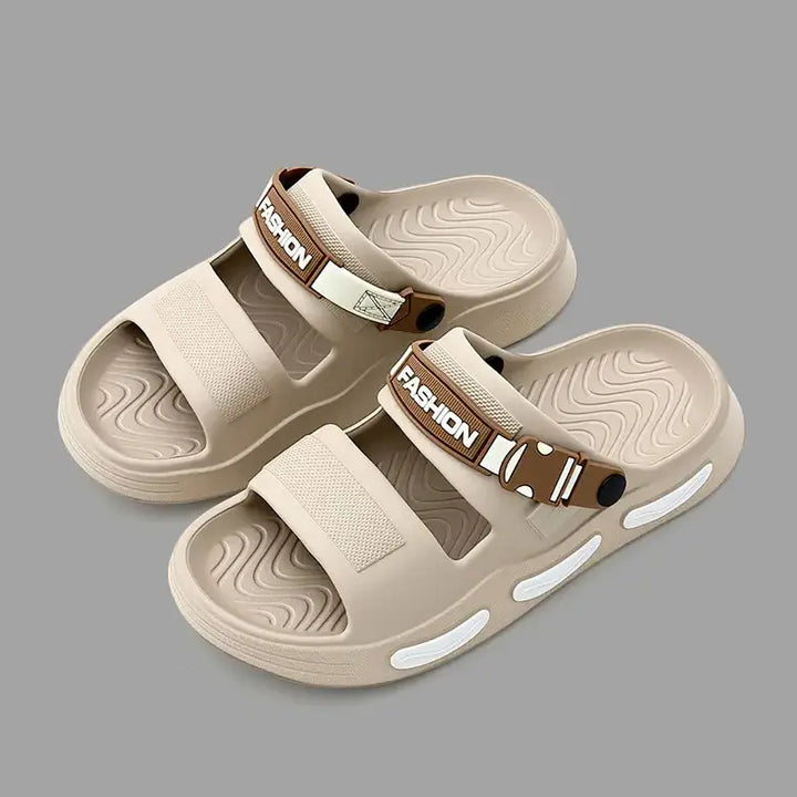A pair of light beige Rhyza chunky platform slide sandals with dual adjustable straps featuring embossed &