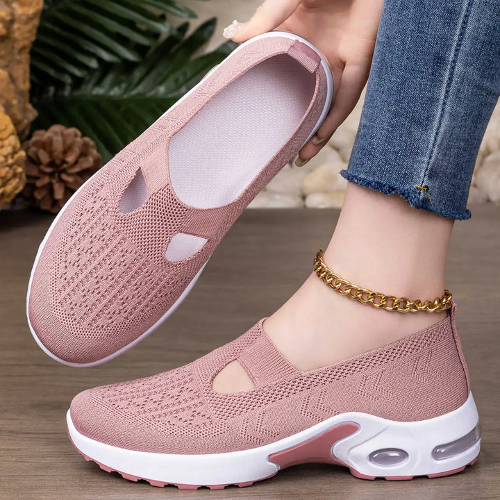 Dusty rose pink Rilux breathable knit slip-on sneakers shown on a foot with a gold ankle bracelet and denim jeans.