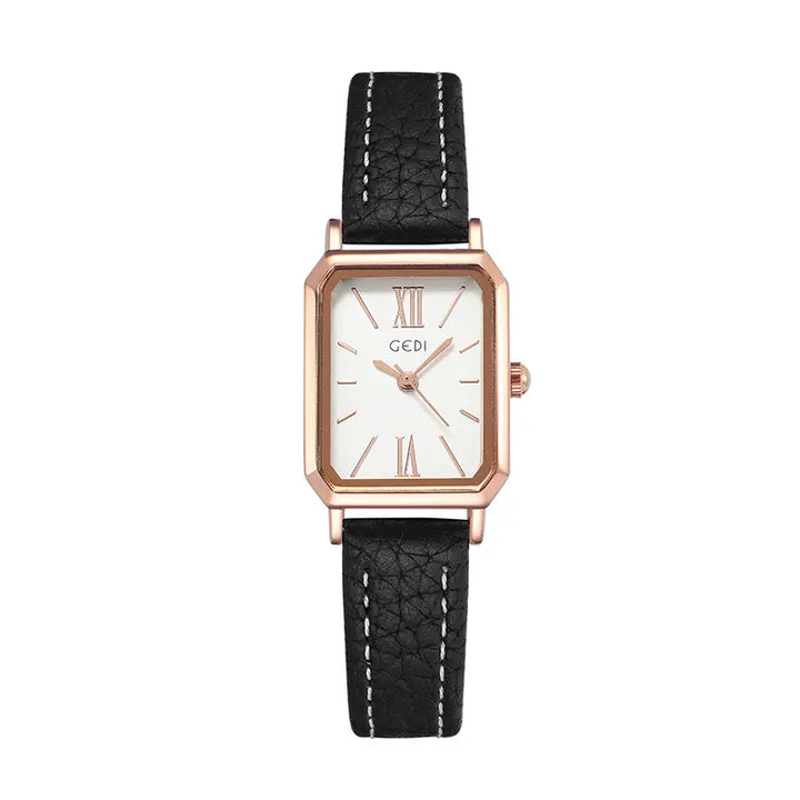 Elegant rose gold rectangular watch with a white analog dial, Roman numeral markers, and a black faux leather strap featuring white contrast stitching.
