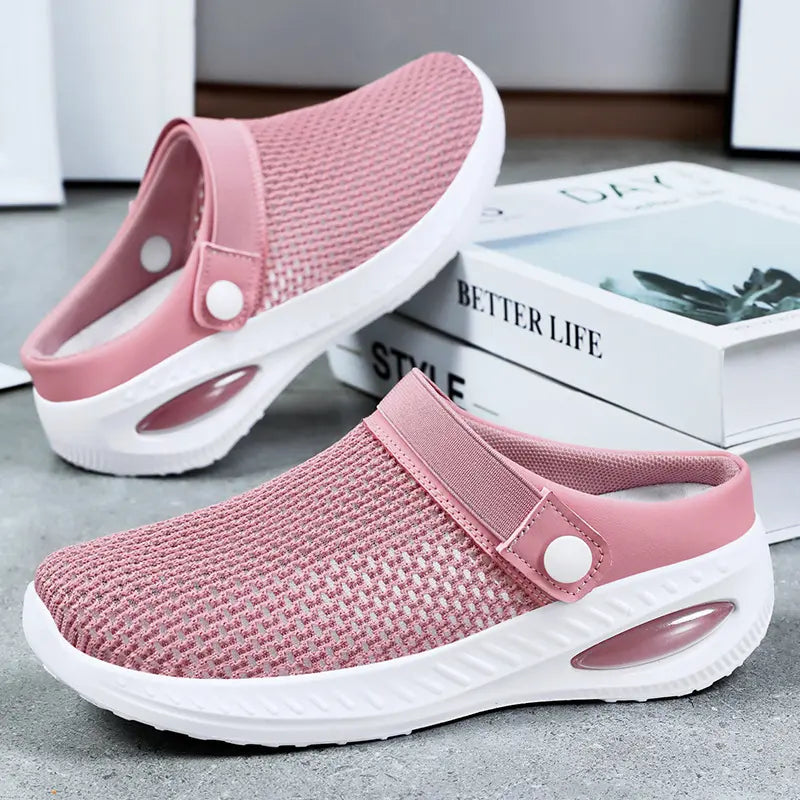 Rose pink breathable mesh clogs for women, featuring a comfortable slip-on design with an adjustable decorative button strap and a white sole with a visible air cushion heel.