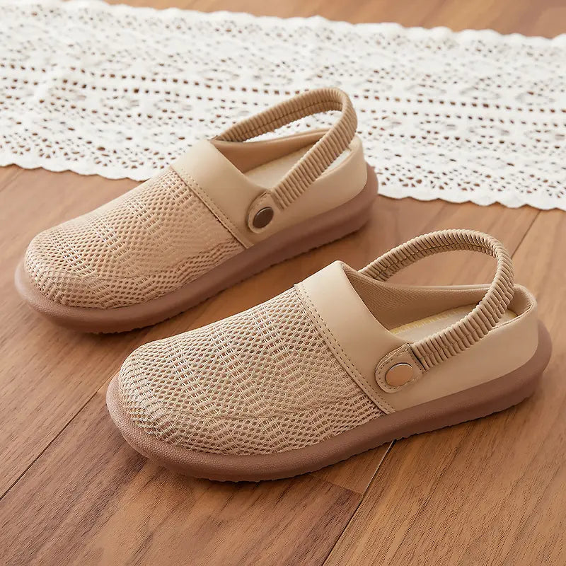 Rovak breathable mesh slides in soft beige, featuring a slip-on design with an elasticated heel strap and a flat rubber sole. These comfortable mules offer all-day airy wear.