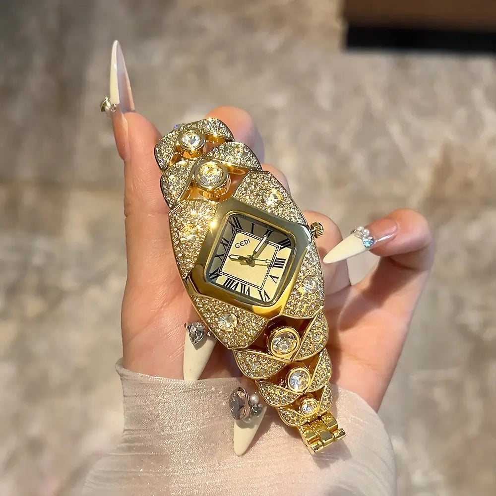 Rydox women's luxury gold crystal bracelet watch with a rhomboid dial held on a manicured hand, showcasing intricate pavé crystal embellishments and Roman numerals.