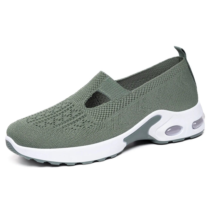Sage green breathable knit slip-on sneaker with air cushion sole, showcasing its comfortable design and modern aesthetic.