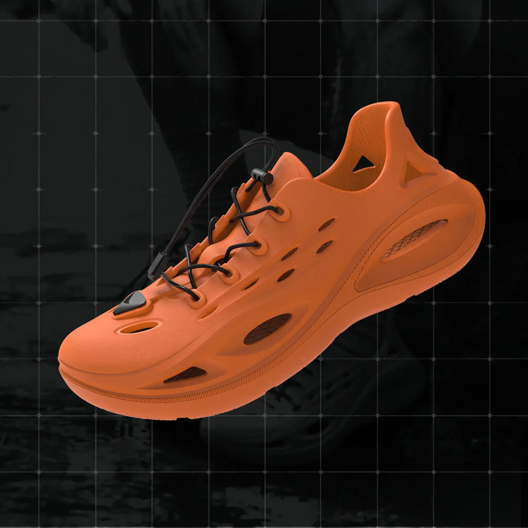 Signal Orange athletic EVA slides with black bungee lace and toggle, featuring cut-outs and a chunky geometric tread sole, presented against a dark studio background.