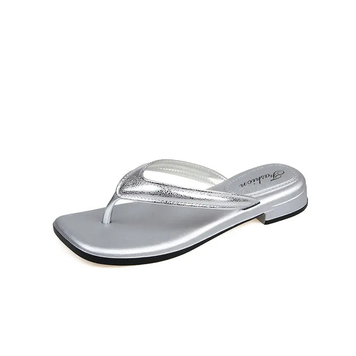 Silver glossy PVC thong sandals with a square toe and a subtle embossed &