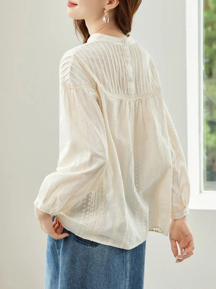 Sorvin embroidered cotton shirt in vintage cream, featuring a high gathered neckline, voluminous bishop sleeves, and a detailed buttoned back closure.