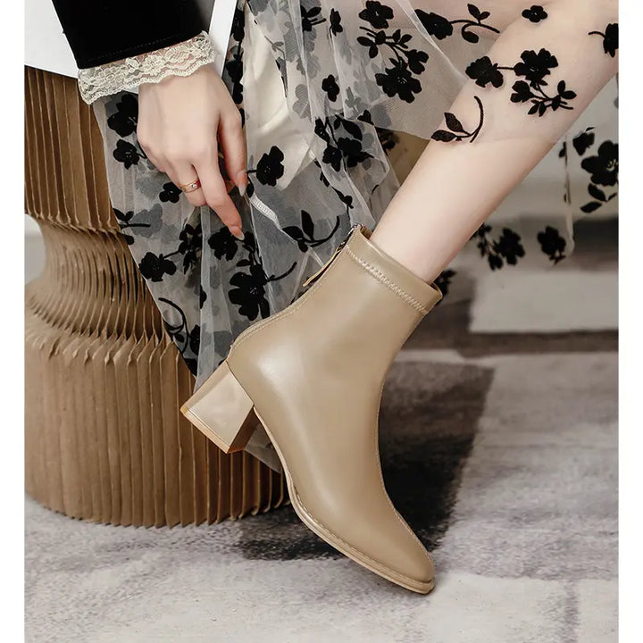 Taupe ankle boots with a square toe and block heel, shown on a model&