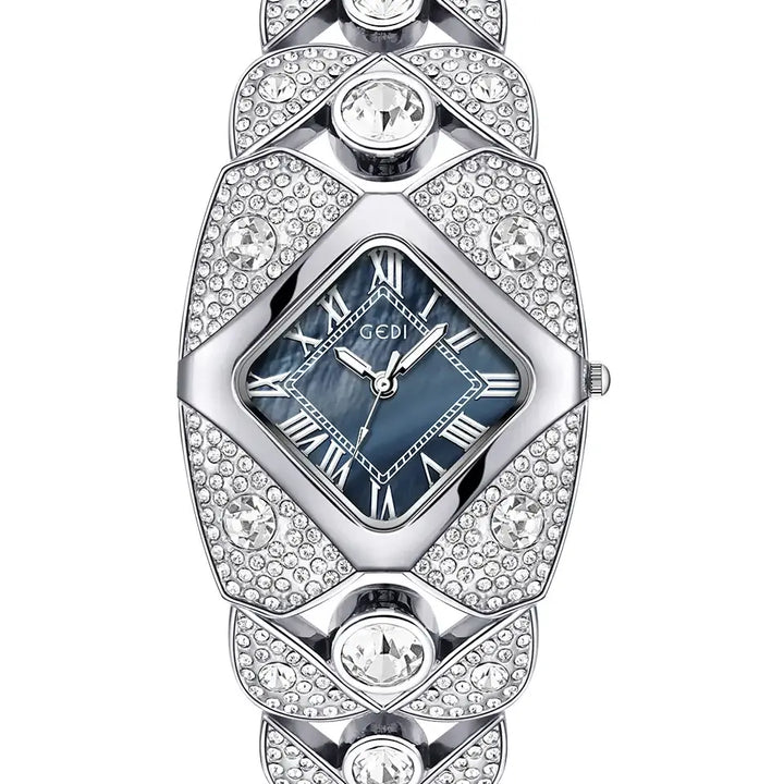 Silver-tone Tavril diamond-embellished bracelet watch with a rhombic blue mother-of-pearl dial and Roman numeral markers, displayed front view.