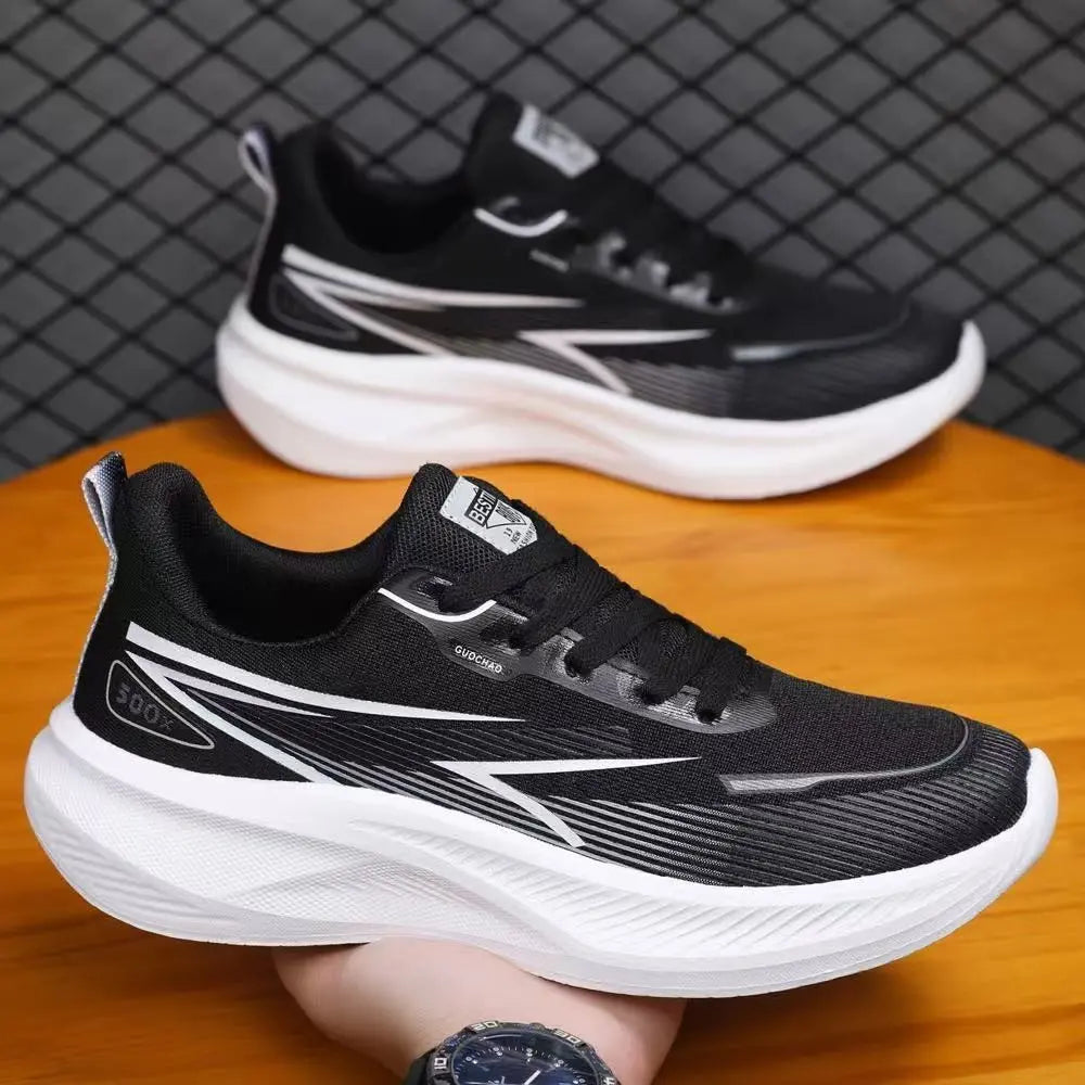 Torvin men's black breathable mesh trainers with dynamic white side stripes and thick white EVA sole, shown from a three-quarter angle with a second shoe in the background.
