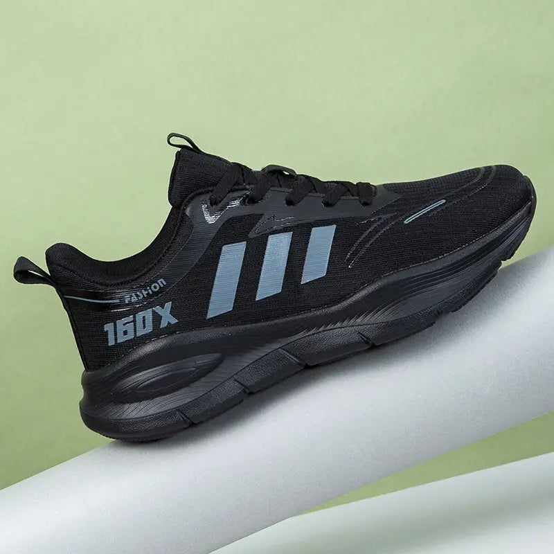 Side view of a black Trovik low-top sneaker featuring a breathable mesh upper, grey three-stripe detail, and chunky sculpted sole with "160X" branding.