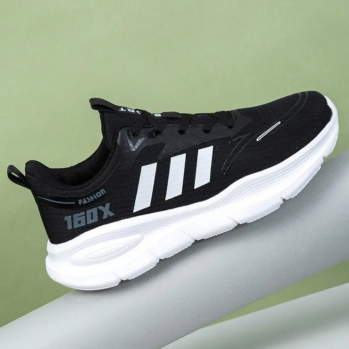 Black Trovik unisex low-top sneakers with a chunky white EVA sole, featuring mint green three-stripe detailing and &