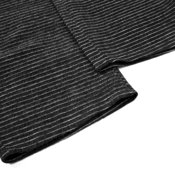 Close-up of charcoal black knit fabric for Vazel wide leg trousers, showing fine white pinstripes and a soft, slightly fuzzy texture with a clean hem finish.