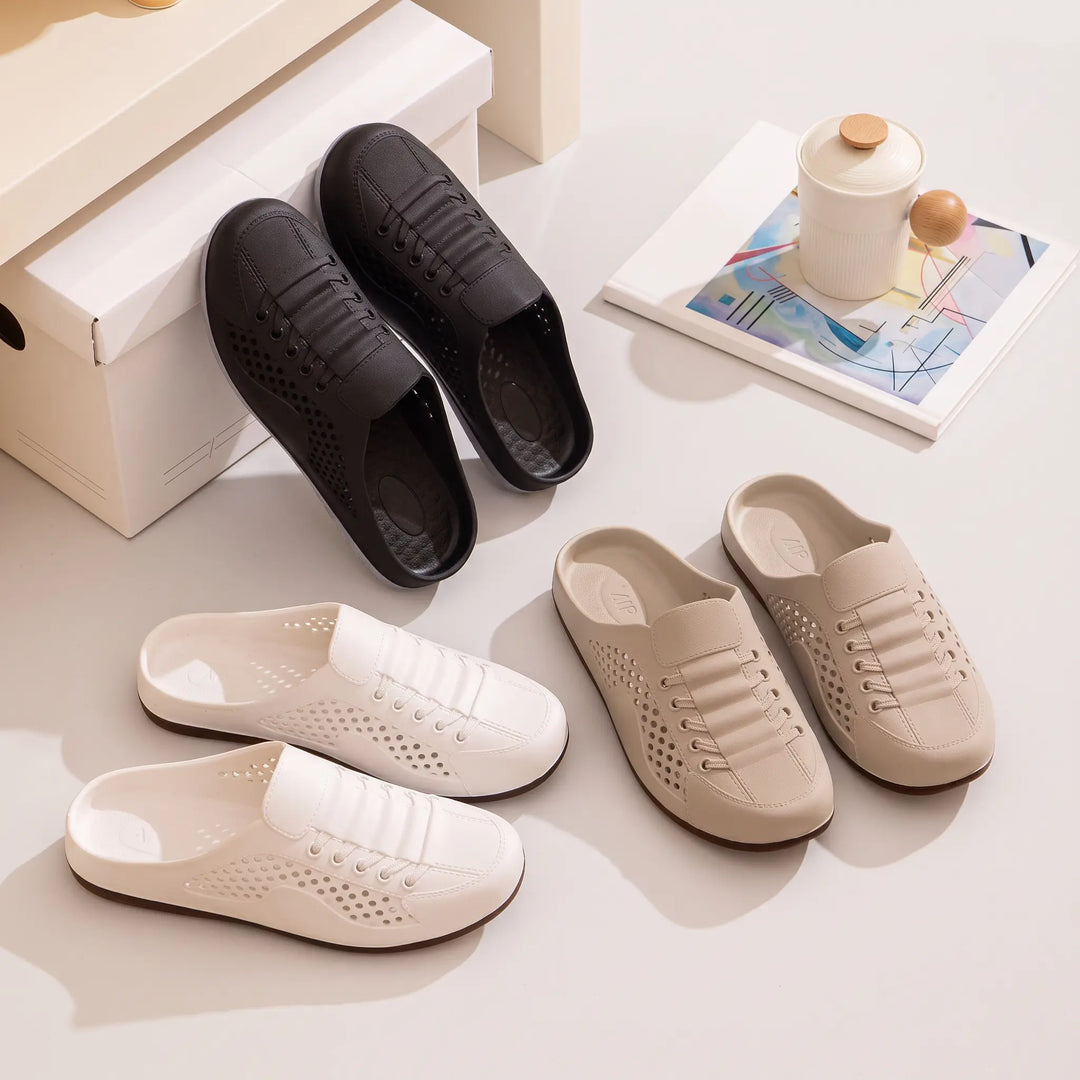 Vervaz breathable clogs shown in white, beige, and black color variants, featuring a perforated design, slip-on mule silhouette, and faux lace-up detail on a studio surface.