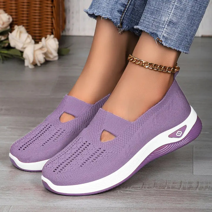 Purple Vespera breathable mesh slip-on trainers worn with denim jeans, showcasing a comfortable, casual, and stylish look with a white midsole and textured outsole.