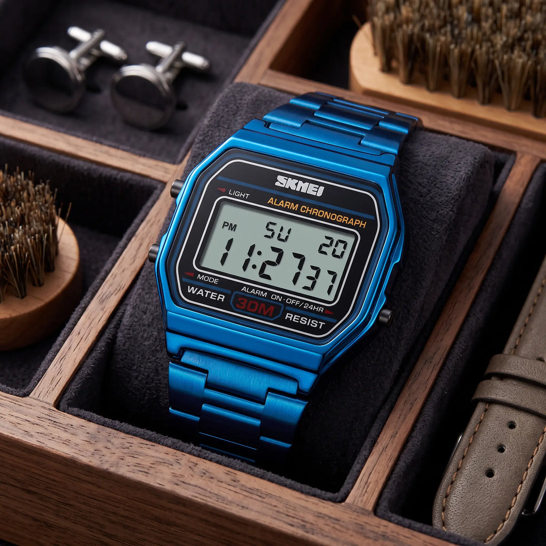 A vibrant blue Vexil retro digital stainless steel watch shown from the front, featuring a polished metal bracelet and a clear digital display with a blue backlight.