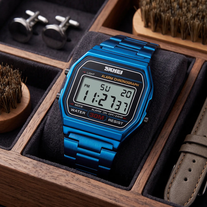 A vibrant blue Vexil retro digital stainless steel watch shown from the front, featuring a polished metal bracelet and a clear digital display with a blue backlight.