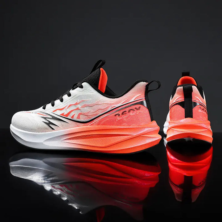 Performance running shoes in white and gradient orange flame graphic, showing side and back views on a reflective studio surface.