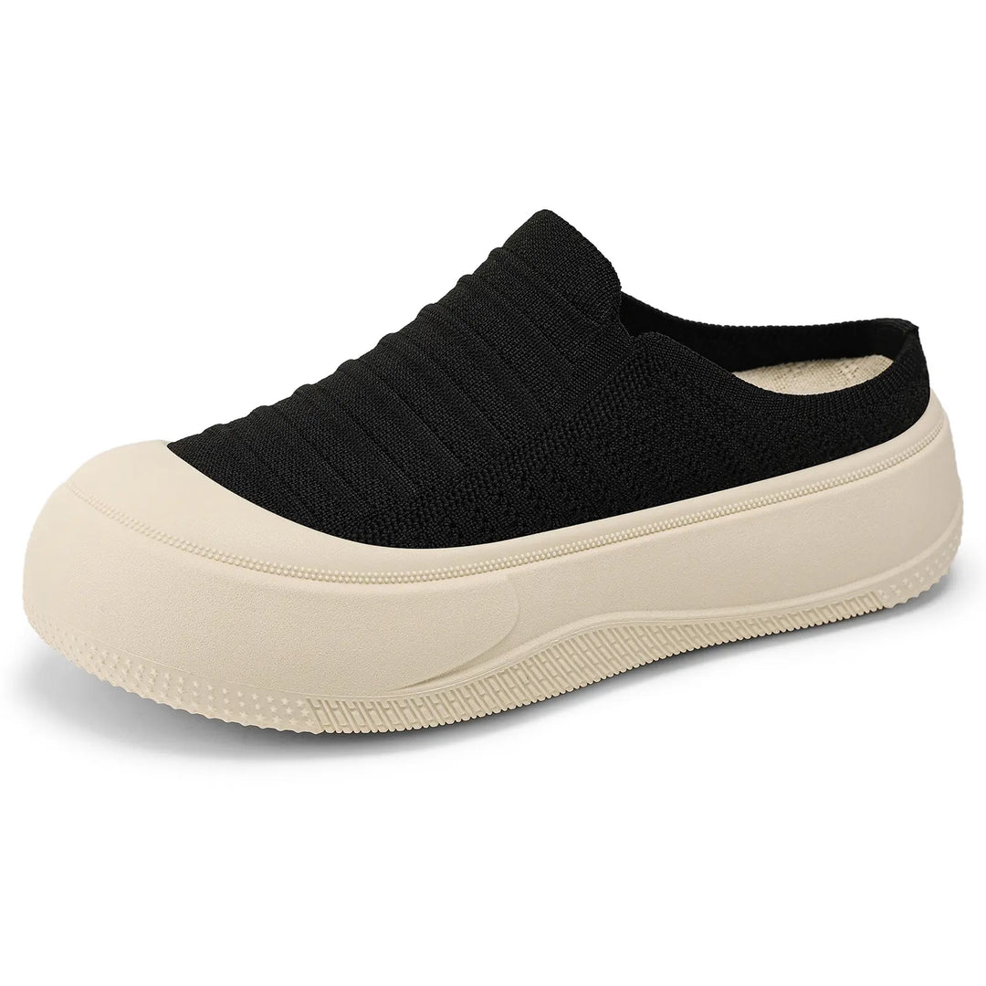 Black Vimera casual platform mules with a finely ribbed knit upper and a contrasting light creamy beige chunky sole. These slip-on shoes feature a closed round toe for modern, comfortable everyday wear.