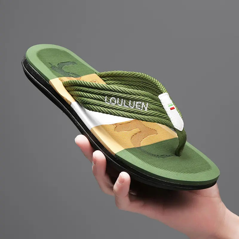 Men's Vorlag flip-flops with a contoured, textured green, tan, and white EVA footbed and braided green textile straps, held in hand against a studio background.