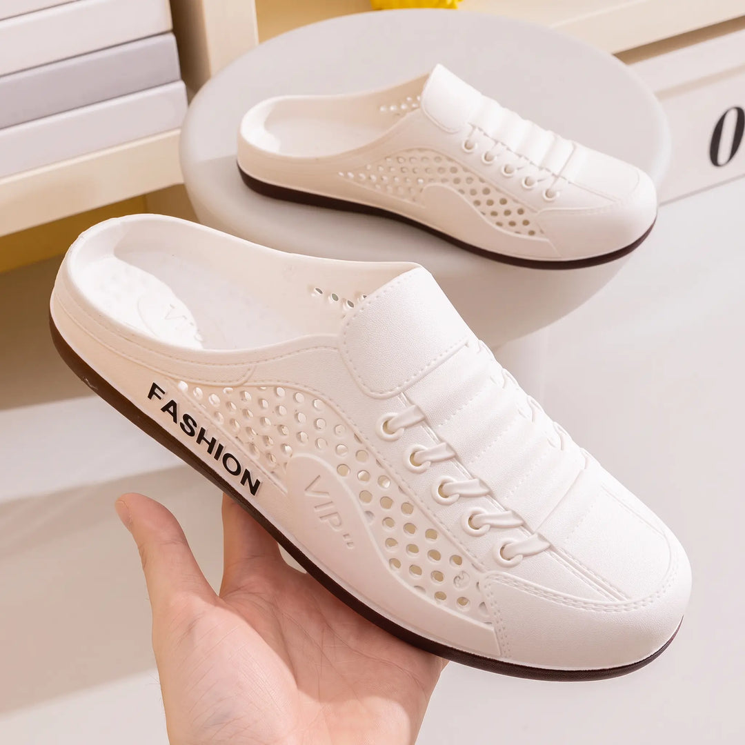 A pair of white slip-on mule clogs with extensive circular perforations, faux lace-up detail, and "FASHION" and "VIP" text branding on the side.