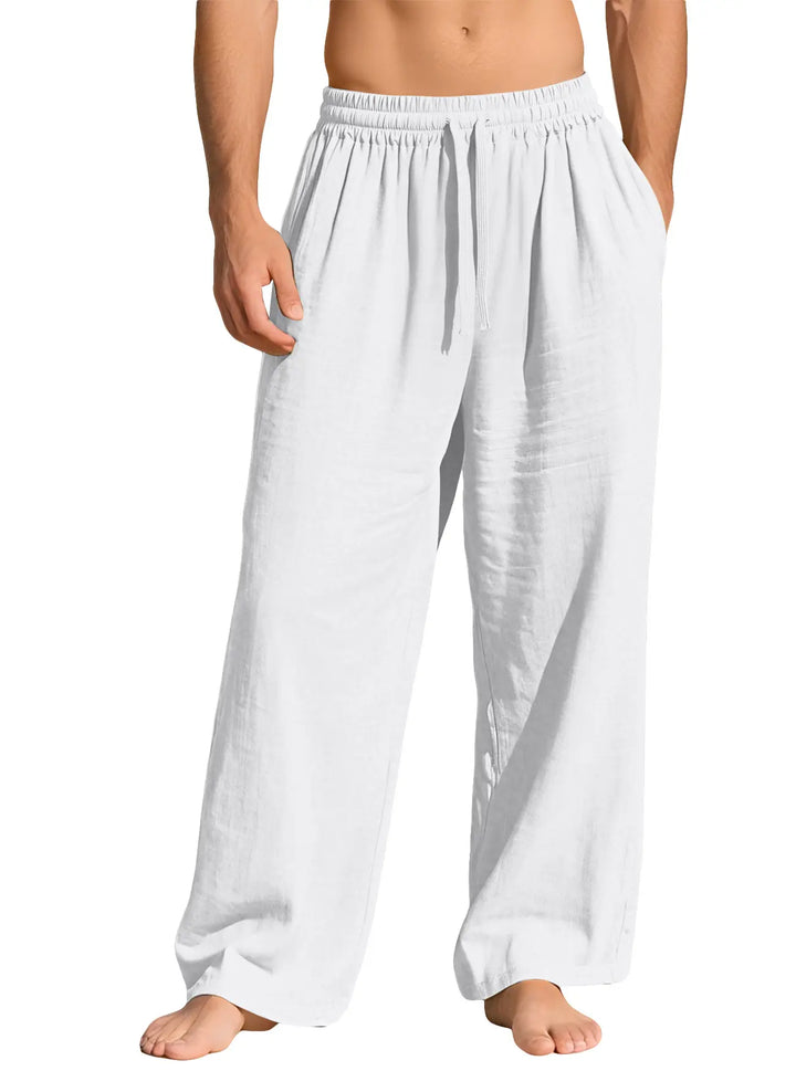 White relaxed-fit linen-blend trousers with an elasticated drawstring waist, shown on a male model from the front on a white studio background.