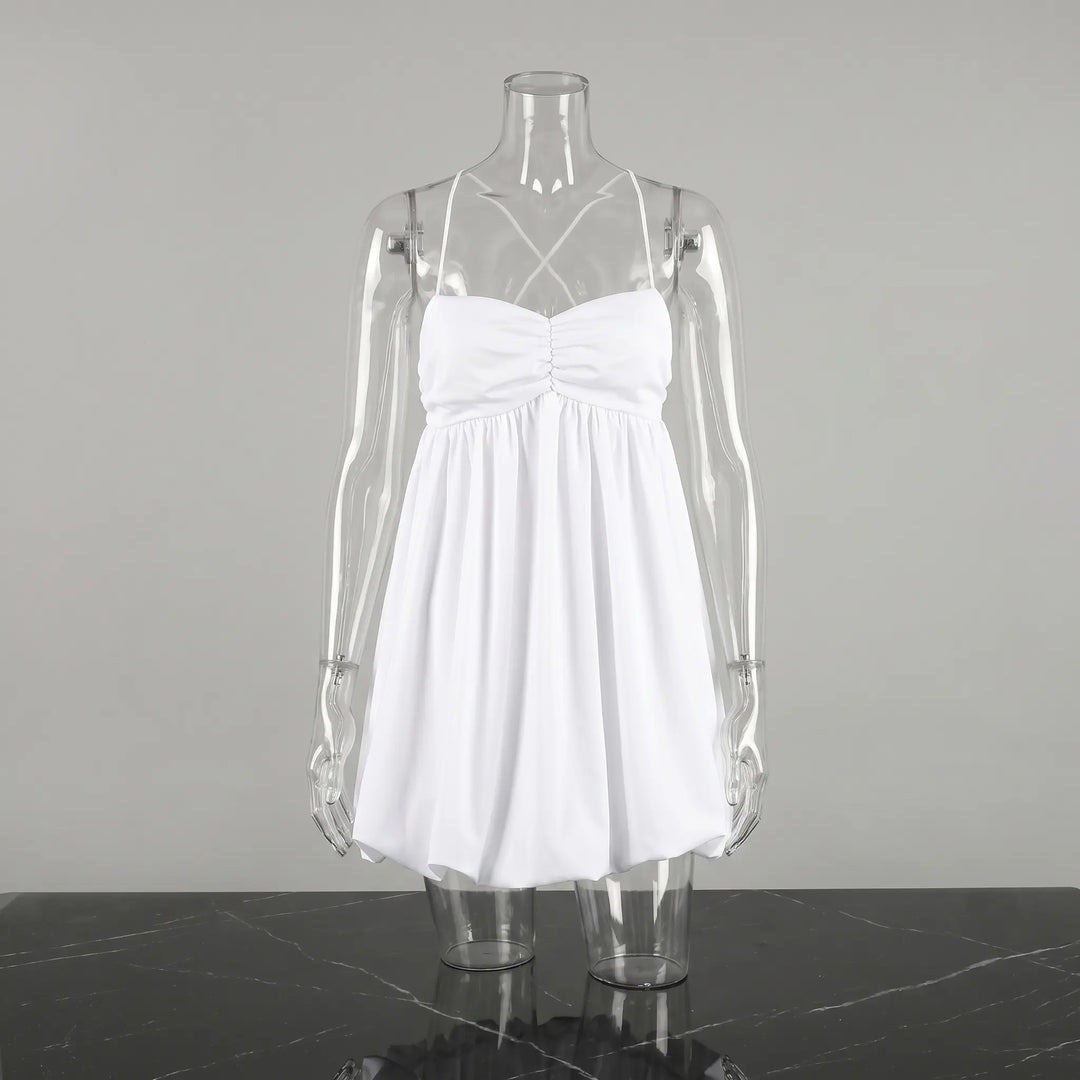 White Axilon halterneck mini dress featuring a deeply ruched bodice and a voluminous bubble hem, displayed on a clear mannequin against a studio grey background.
