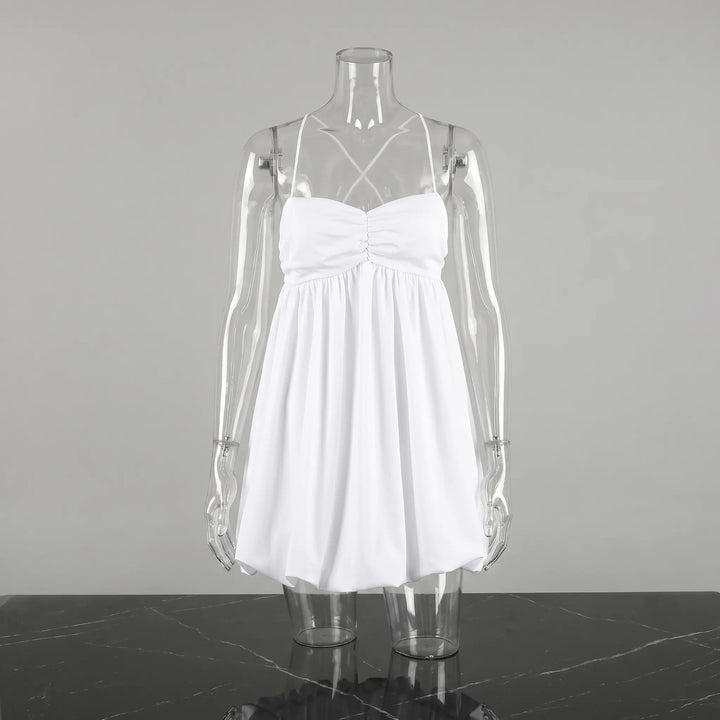 White Axilon halterneck mini dress featuring a deeply ruched bodice and a voluminous bubble hem, displayed on a clear mannequin against a studio grey background.