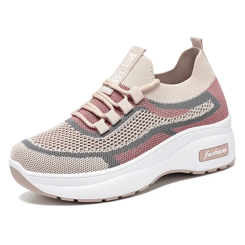 Chunky platform trainers for women in a blush pink and grey knit, featuring a striped pattern, lace-up closure, and a white platform sole with subtle &