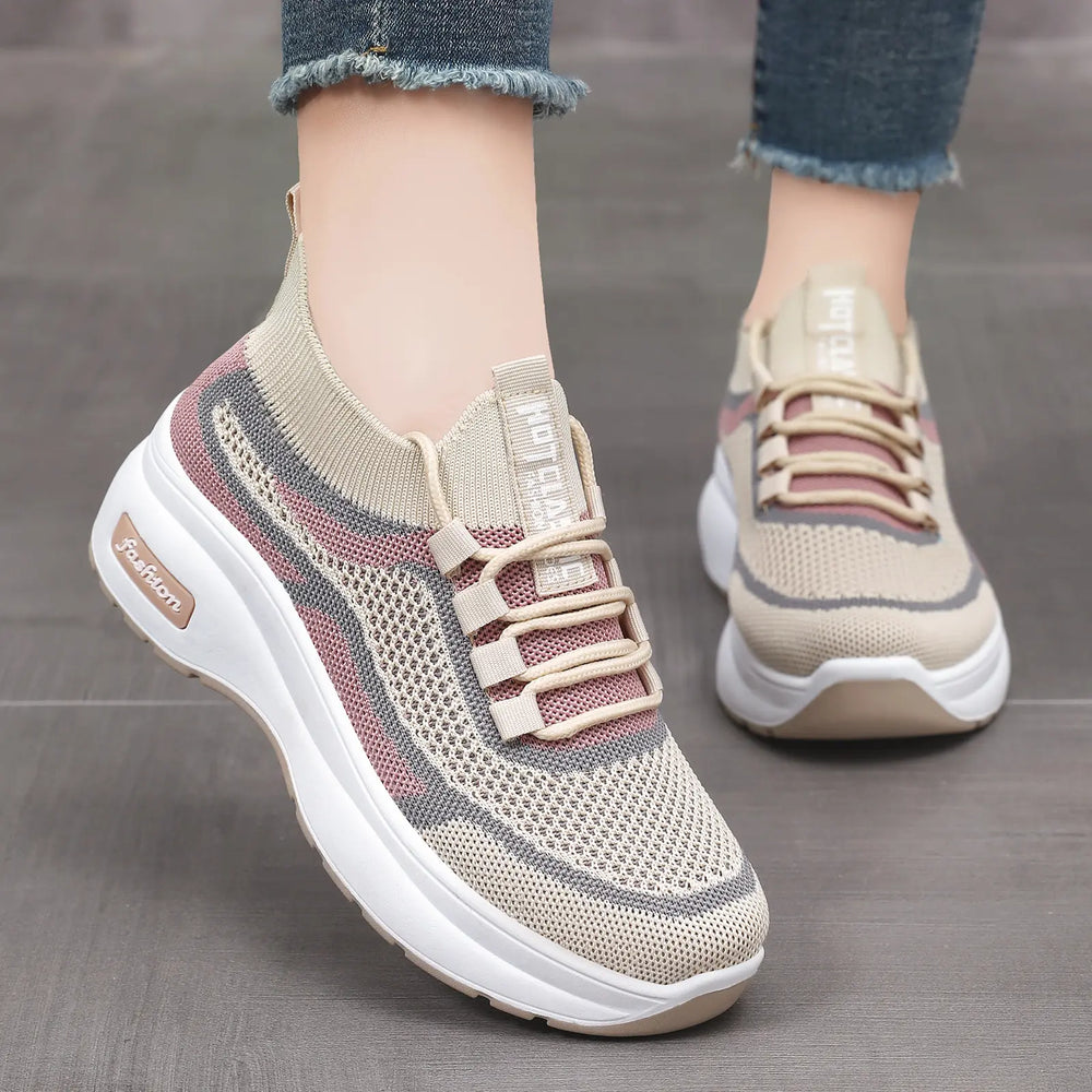 Women's blush pink knit platform trainers with a striped pattern, featuring grey lace-up closure and a chunky white sole embossed with 'fashion'.