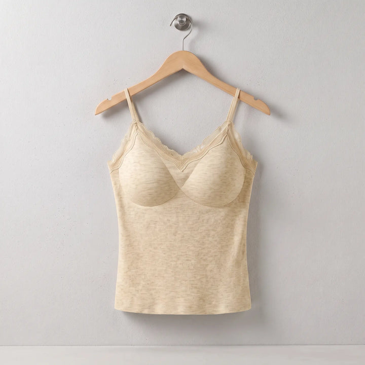Warm Champagne Xylos silk camisole thermal top featuring fine vertical ribbing, delicate lace V-neck trim, and adjustable spaghetti straps, shown on a hanger against a studio background.