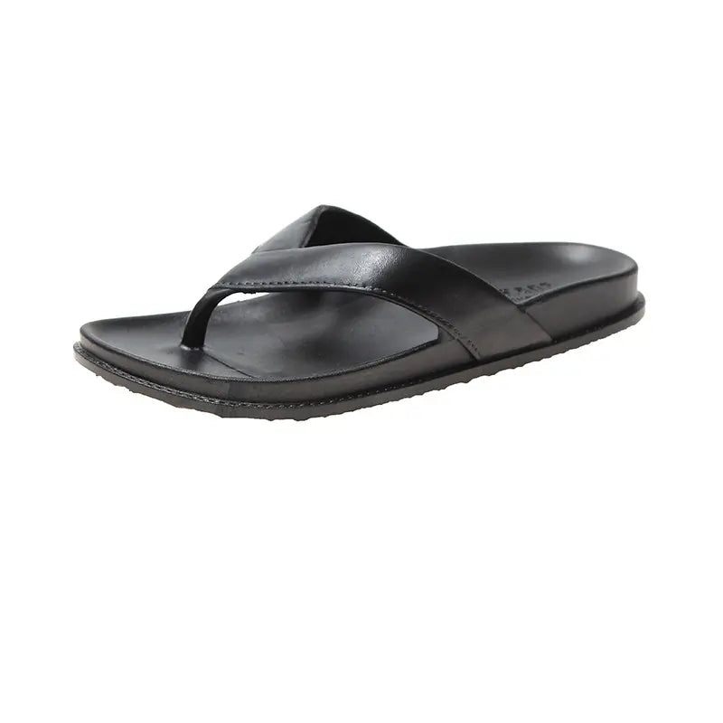 A pair of Zenthel black casual comfort sandals shown from a three-quarter front view on a clean white background. These unisex flip-flop style sandals feature a smooth matte faux leather wide cross-strap and a contoured ergonomic footbed.