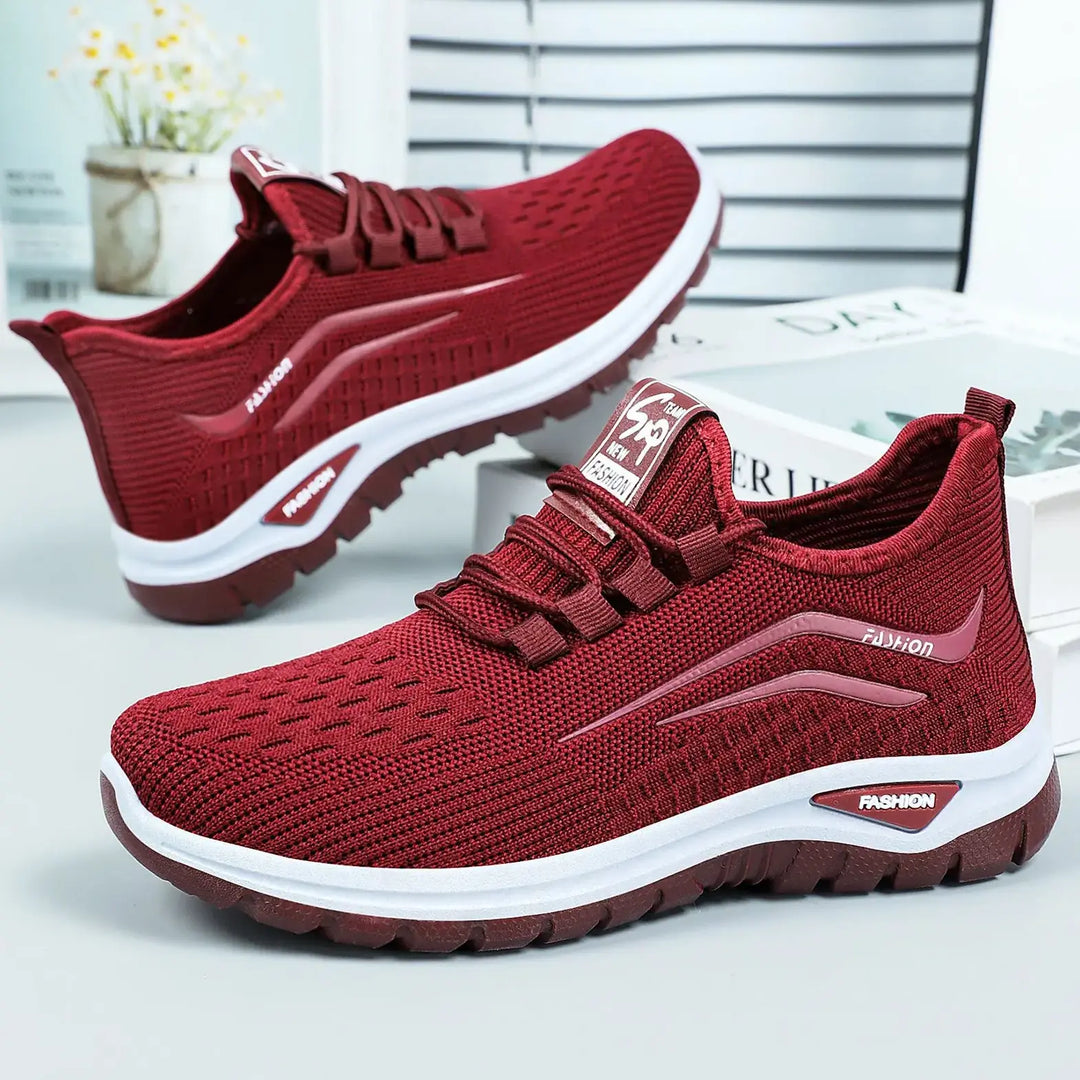 Crimson red Zentiva breathable knit trainers for women, featuring a sleek, low-top design with integrated lacing and a contrasting white and red sole.