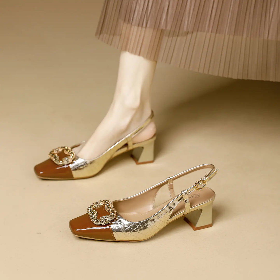 Luxe gold metallic textured slingback heels with a brown patent square toe and a crystal-encrusted square buckle, shown on a model&