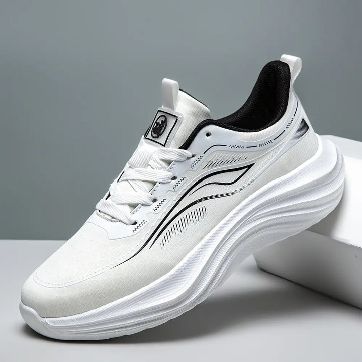 Zephyrin lightweight performance sneakers in pure white, showcasing a breathable engineered mesh upper and a sculpted white EVA sole from a three-quarter angle.