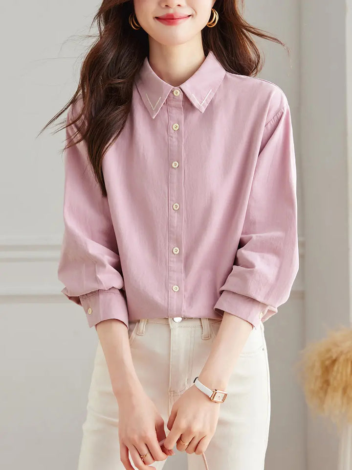 Zoryan chic pink embroidered cotton shirt with a classic polo collar and button-front, shown on a model in a studio setting.