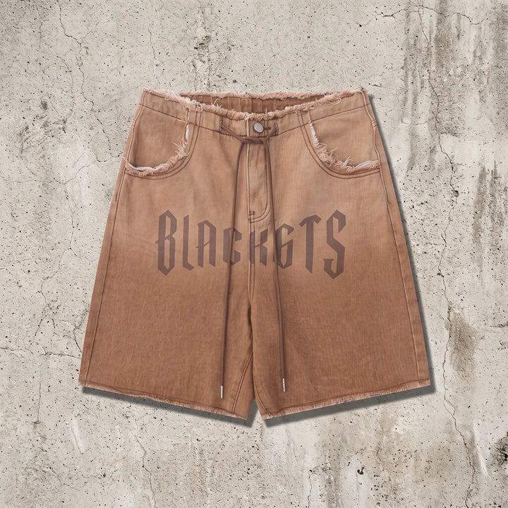 Zykra wide leg denim shorts in gradient wash from brown to dusty rose, featuring distressed frayed hem, drawstring waist, and bold &
