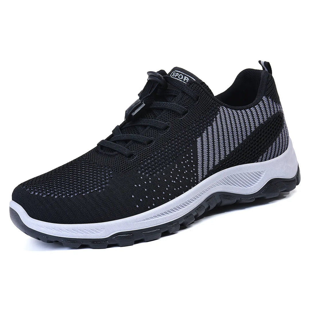 Black lightweight walking trainers with a multi-tonal grey knit mesh upper, featuring a quick-lace toggle system and a white sculpted midsole with a grey rubber outsole.