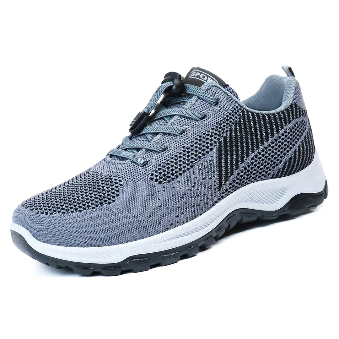 Grey lightweight walking trainers featuring a breathable knit mesh upper with a patterned design, a practical quick-lace toggle system, and a supportive white and black sole.