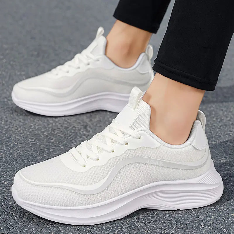 White men's Zylos breathable mesh lightweight trainers are shown from a slightly elevated side view, worn with black trousers on a grey textured ground.