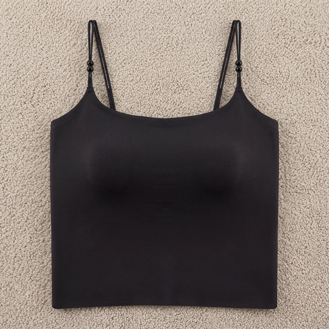 Black seamless camisole featuring integrated 4cm molded cups, delicate adjustable spaghetti straps with pearl accents, and a wide stabilizing hemband for a smooth silhouette.
