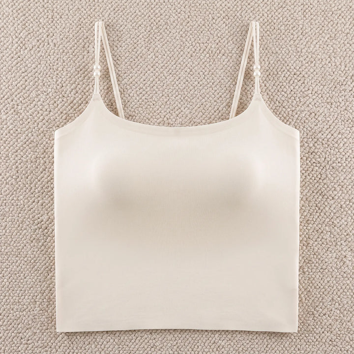 Zylovo seamless camisole in champagne white, featuring integrated 4cm molded cups, adjustable pearl-accented spaghetti straps, and a wide elasticated hem for sculpted comfort.