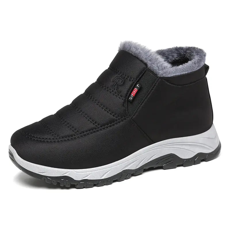 Zylpha black quilted slip-on winter boots for men and women, featuring plush faux-fur lining, a durable rubber lug sole, and a visible &