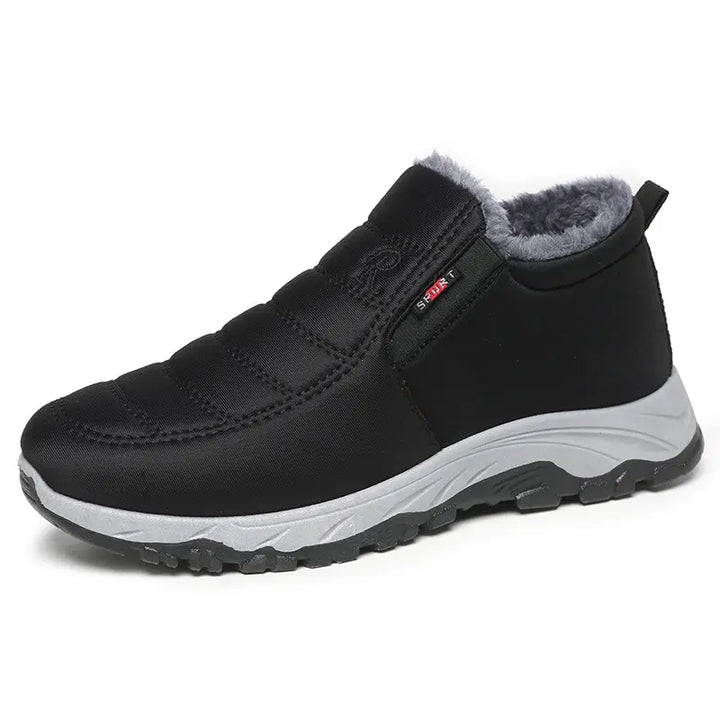 Black quilted synthetic winter boot with plush faux-fur lining, round toe, and durable rubber lug sole, shown in a three-quarter front view.