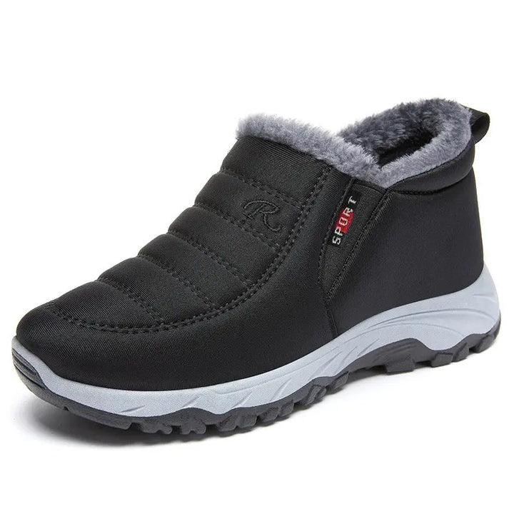 Black Zylpha warm winter ankle boots with faux-fur lining, quilted upper, and a durable rubber lug sole. Features easy slip-on design and side SPORT label.