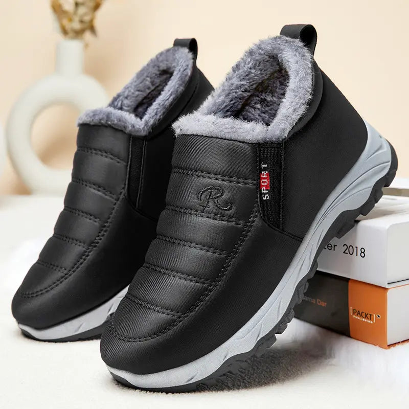 Zylpha black quilted synthetic winter boots with plush faux-fur lining, 'SPORT' tab, and durable rubber lug sole, shown from a front three-quarter angle.