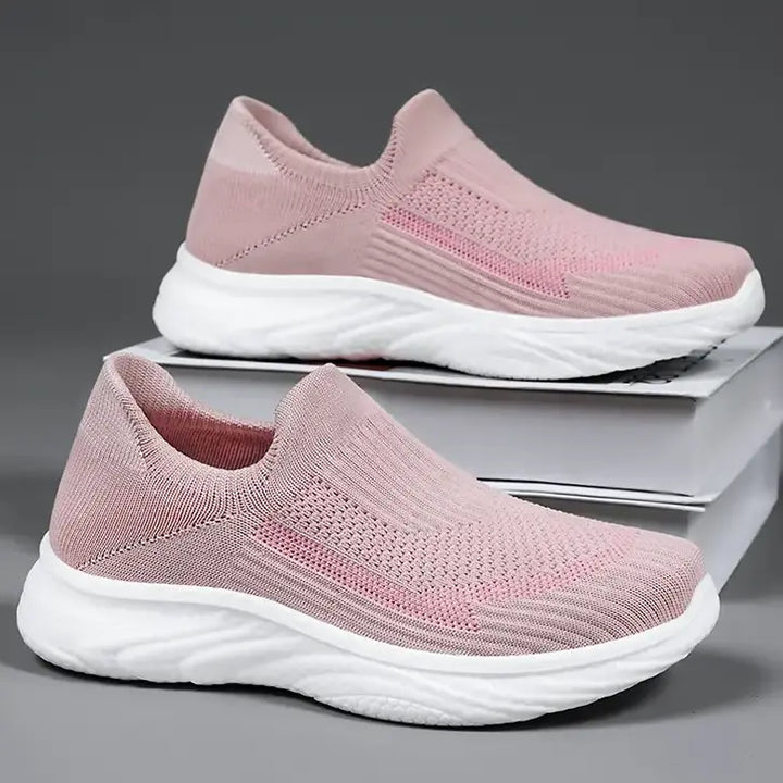 Two pairs of pink Zylpha casual slip-on sneakers with white sculpted soles, shown from a three-quarter angle on a studio background.